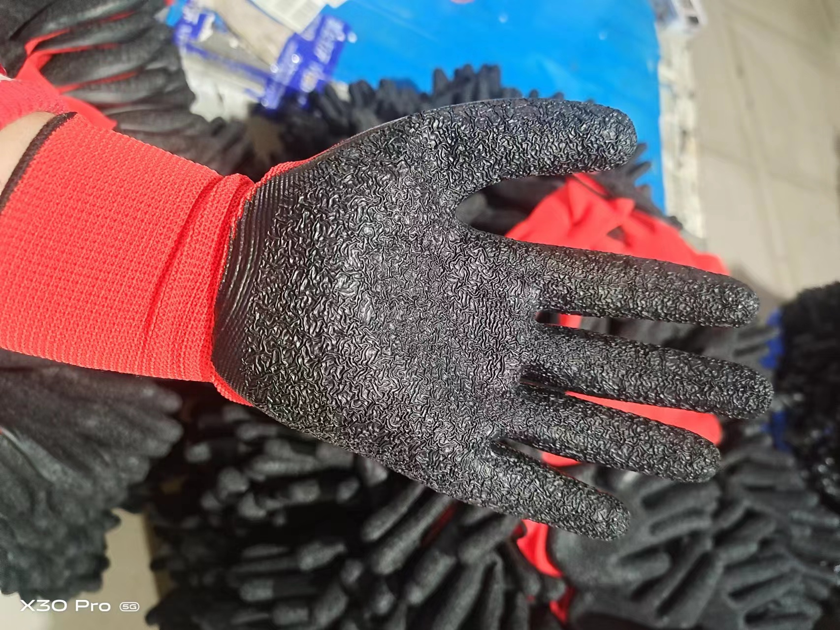 Red and black latex coated work glove for industrial use